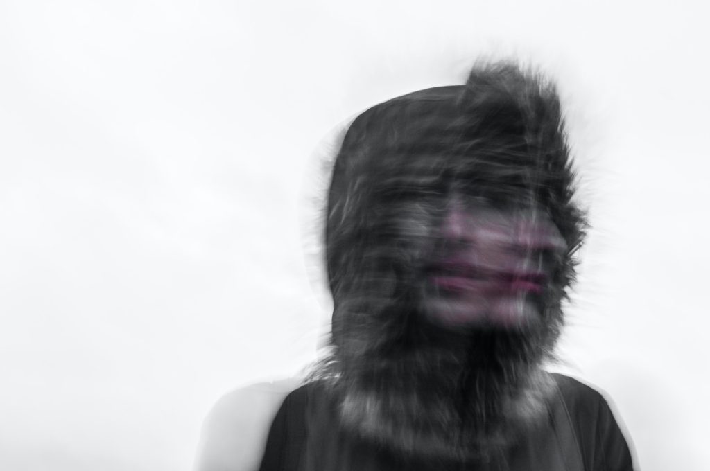 Creepy blurred photo of a person's face and a furry hood trauma ptsd