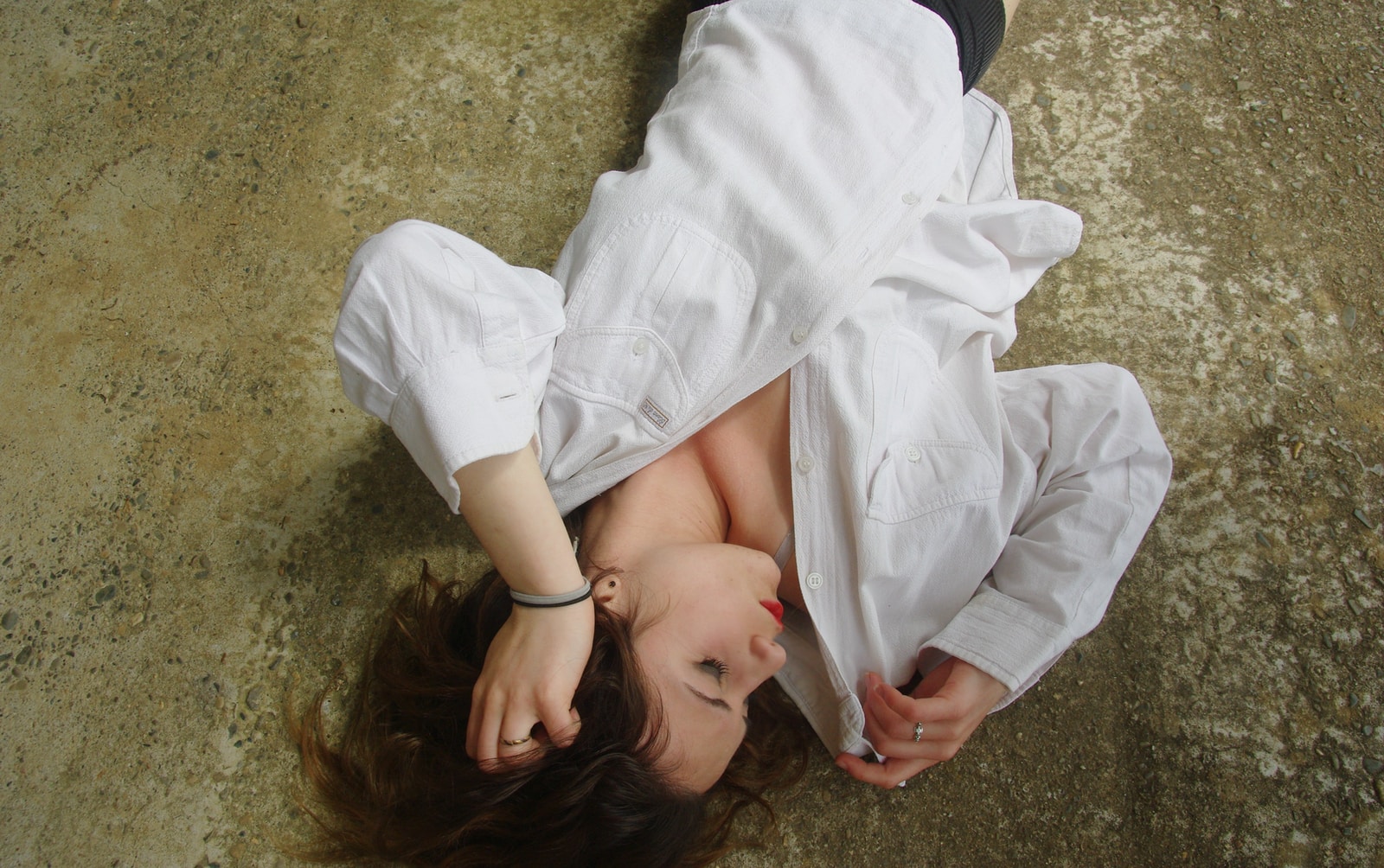 woman sleeps in white dress shirt