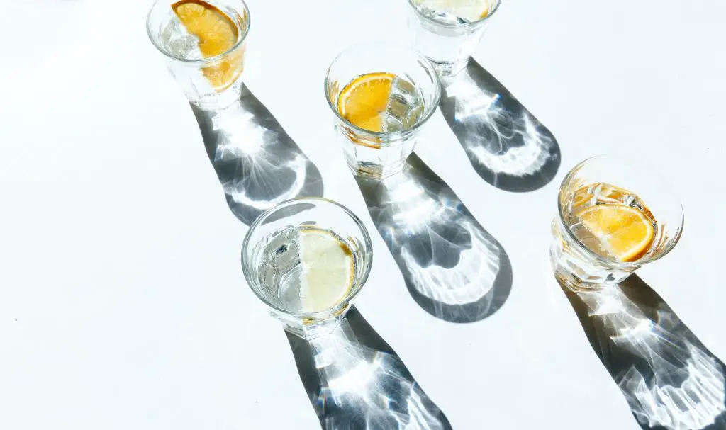 five clear shot glasses water drink