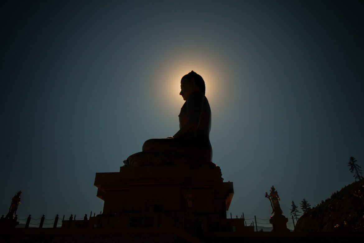 silhouette photo of Buddha statue commanding position