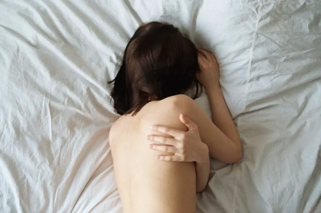 woman lying on white bed naked sleep