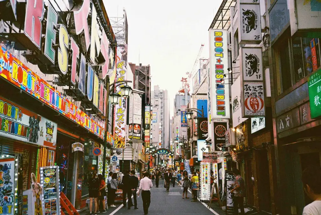 What Time do the Japanese Wake Up? - Late Sleep, Early Rise 3 people walking between high-rise buildings japan