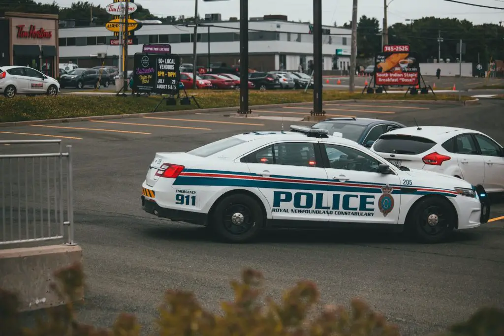 13 Safe Places To Sleep in Your Car - for Free 7 white and blue police car at station