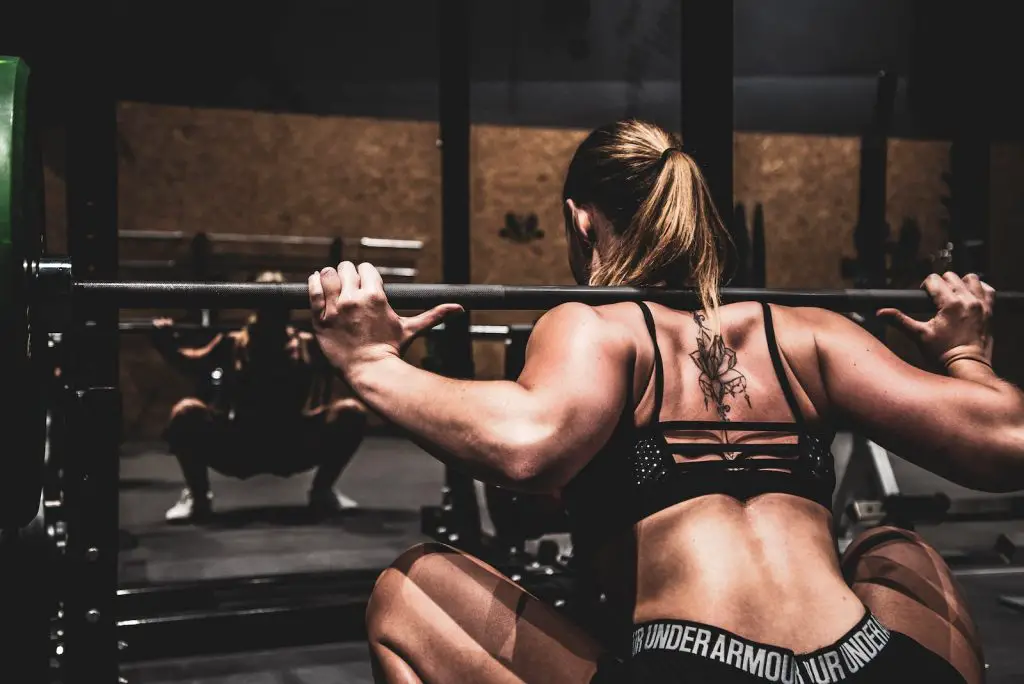 Wolf Chronotype: Sleep Like a Wolf and Optimize Your Life 2 woman lifting barbel workout