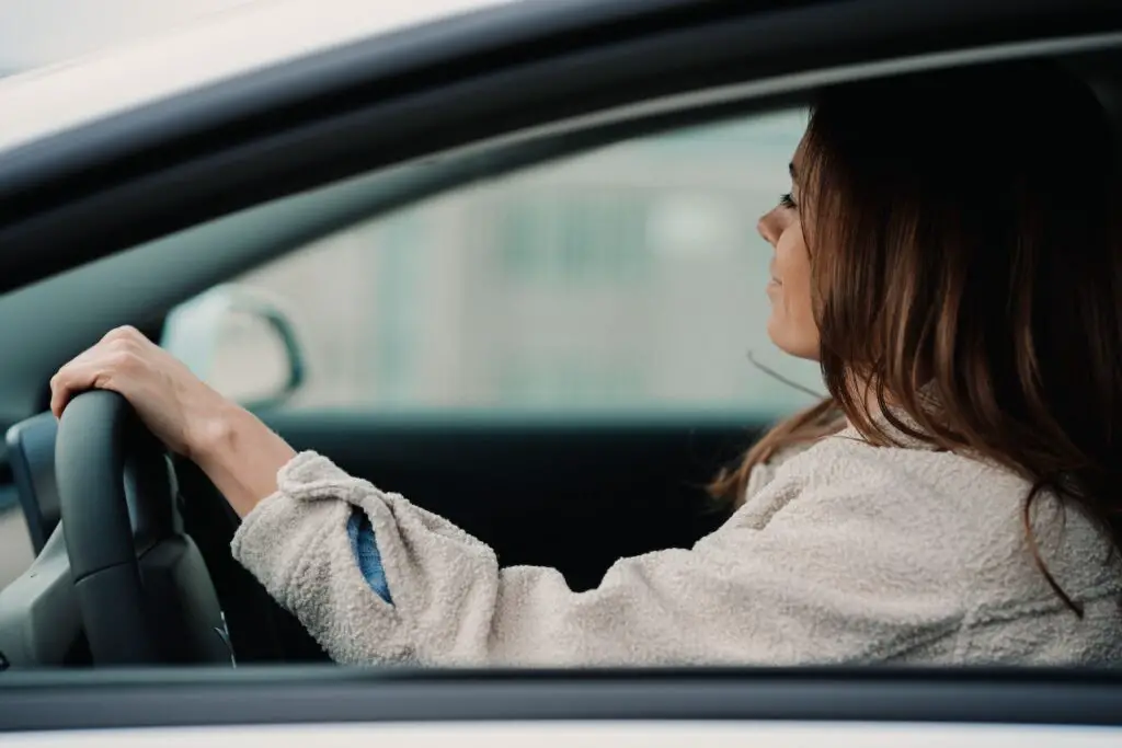 Can You Get Jet Lag From Driving? - and How to Avoid It 3 woman in gray hoodie sitting inside car during daytime with jet lag