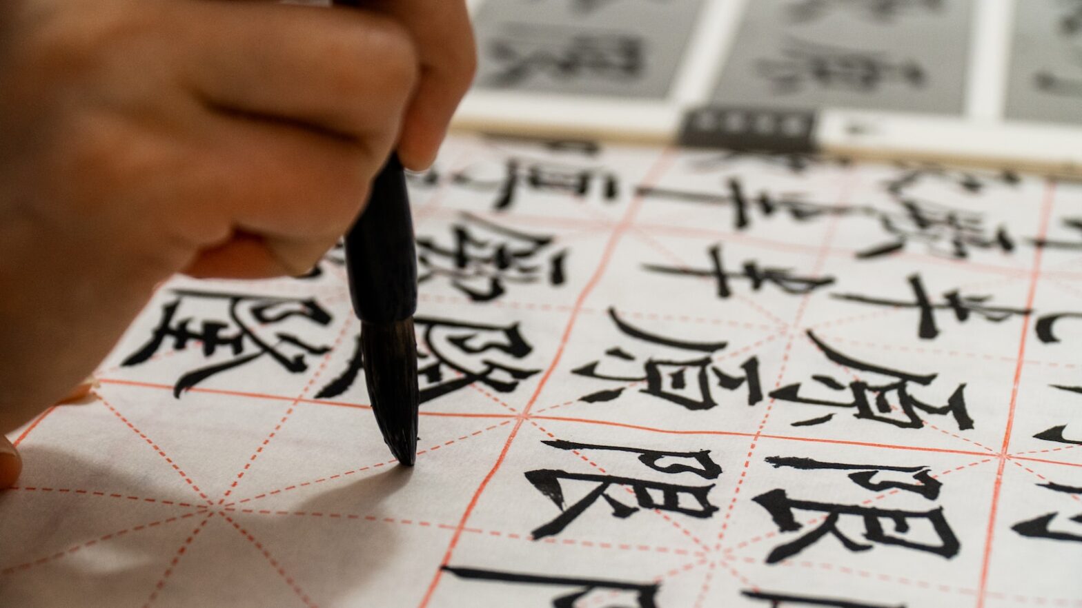 person writing on white paper chinese